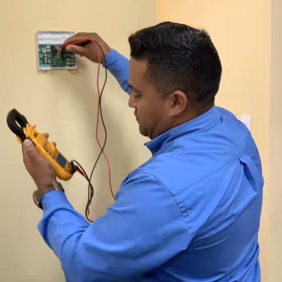 HVAC technician performing air conditioning maintenance in Cypress, TX