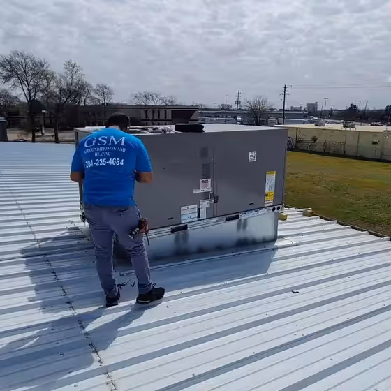 Heating system repair specialist working on HVAC unit